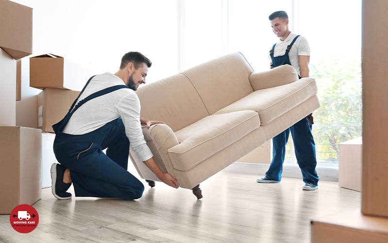 Delivery Men Moving sofa In Room At New Home