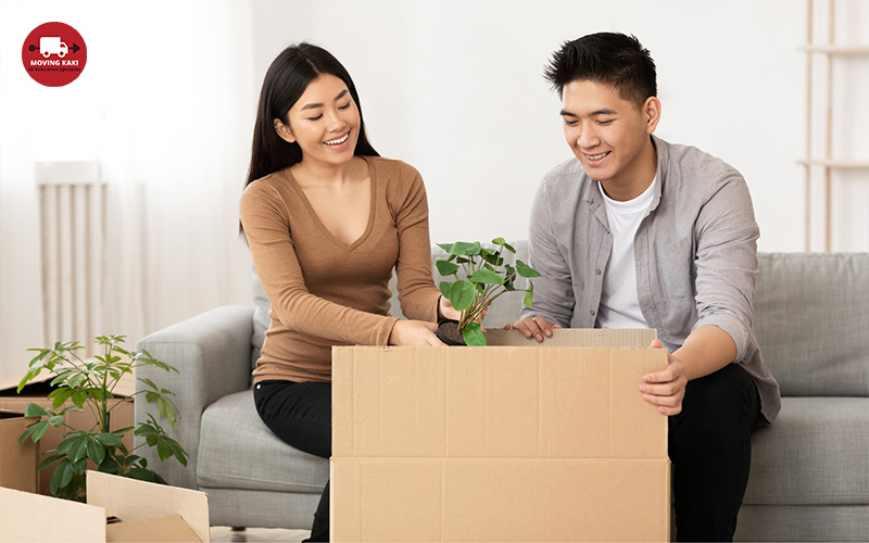 happy couple packing their plants