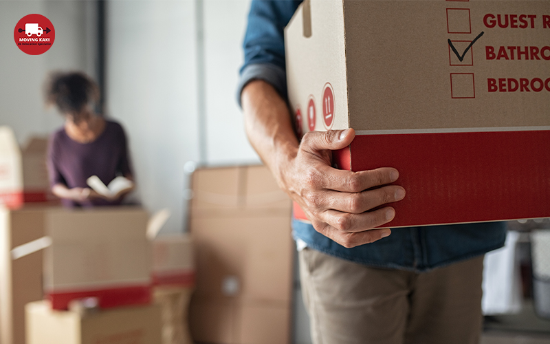 Man Carrying Box While Moving Into New Home