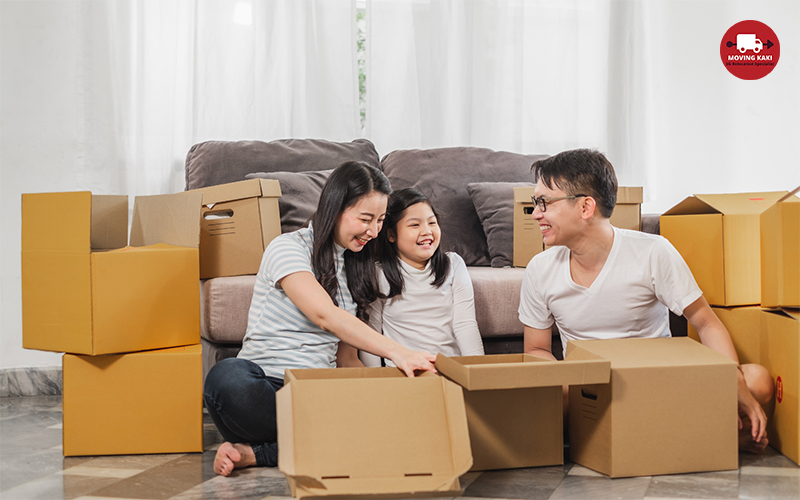 Asian family father mother daughter packing cardboard box for storage solutions from Moving Kaki